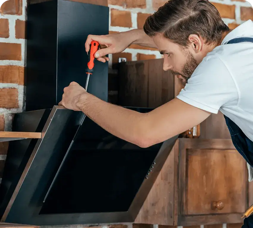 Technician repairing a home appliance in Ajax