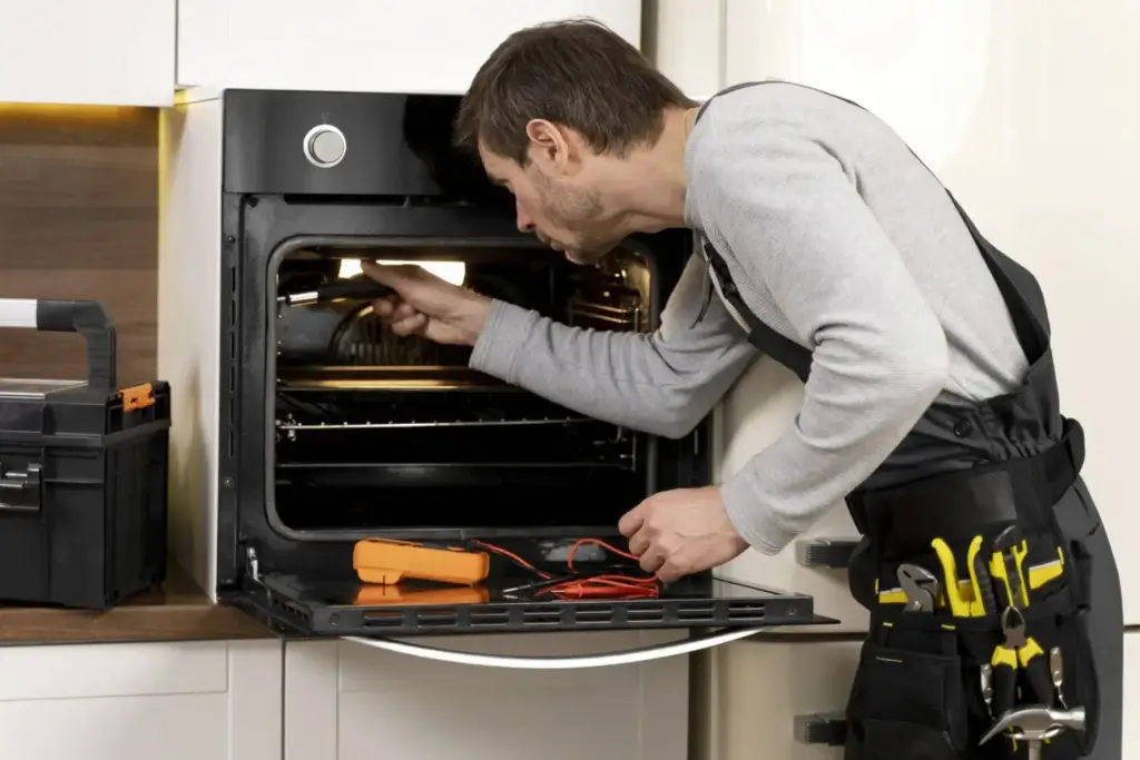 Technician repairing an oven that isn’t heating properly