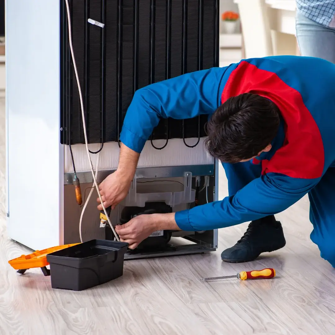 Certified appliance technician repairing refrigerator in Toronto