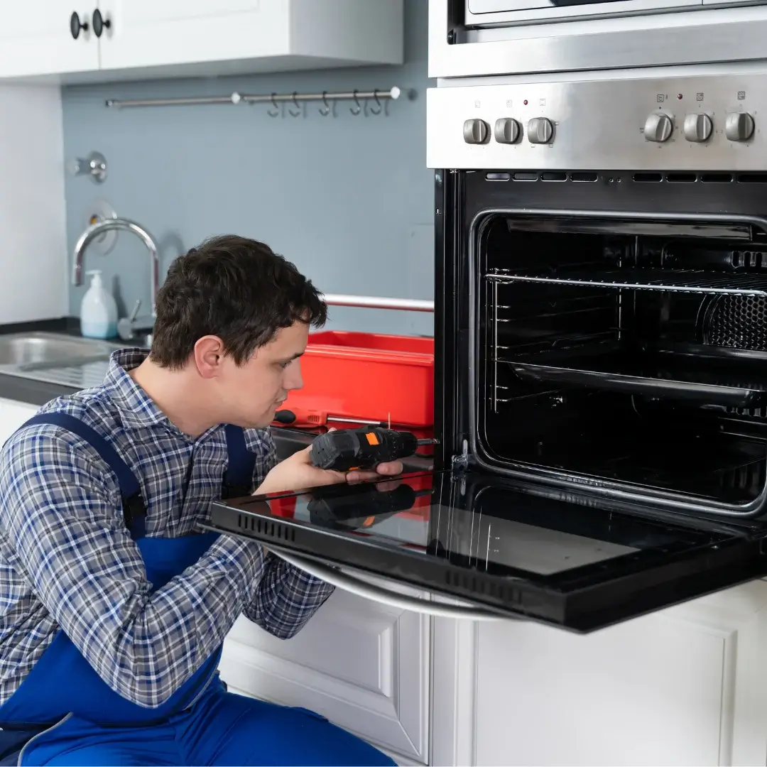 Certified technician repairing oven in Toronto kitchen
